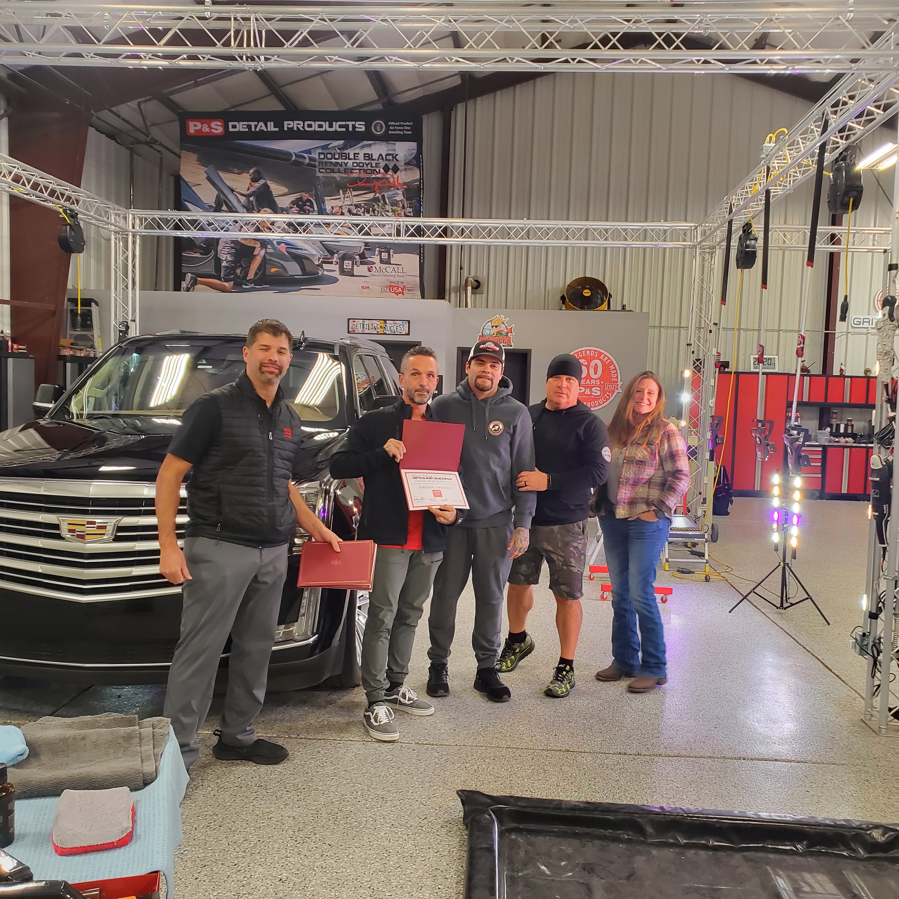 Jersain Orozco receiving award at automotive detailing event